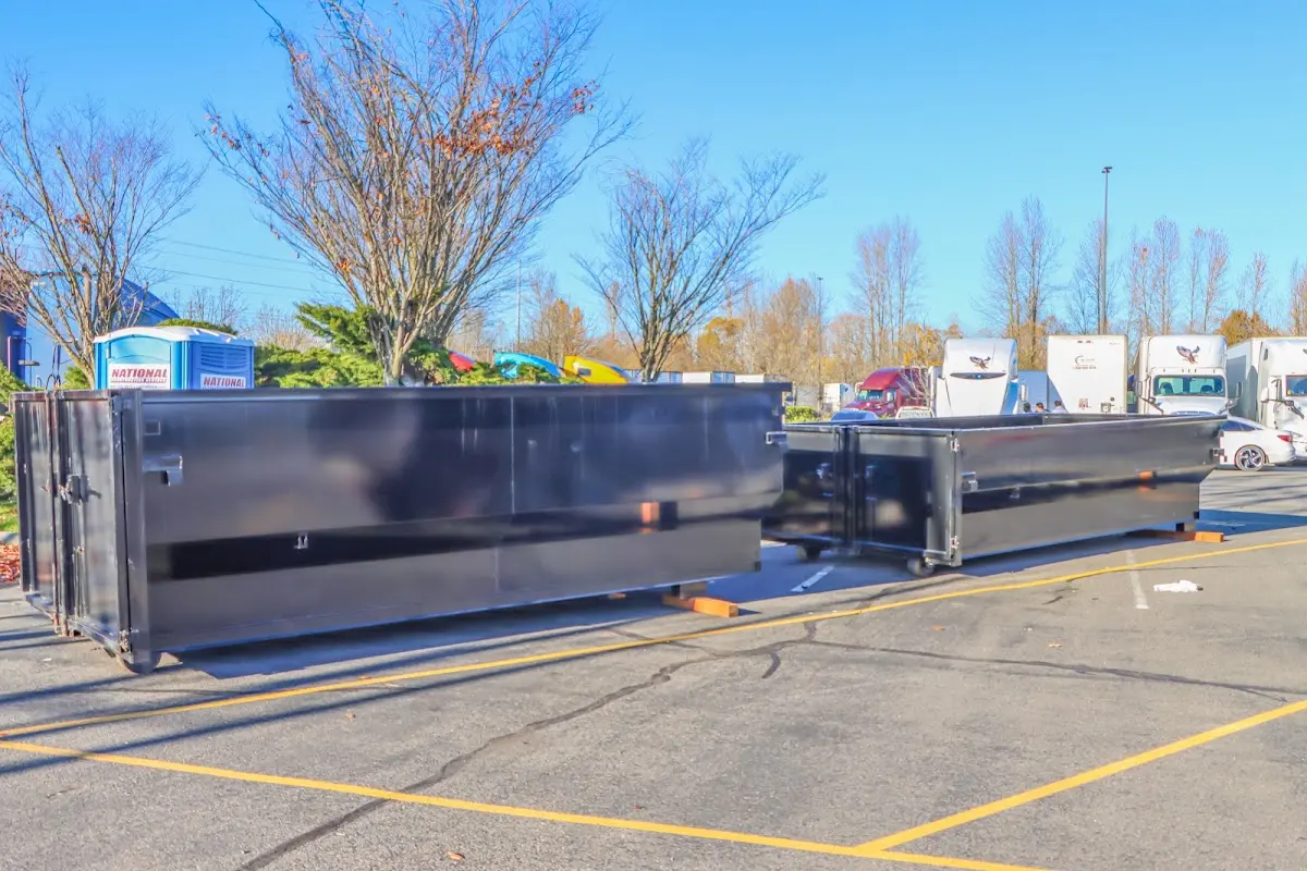 Professional dumpster rental service with roll-off container on residential driveway in Country Club Hills